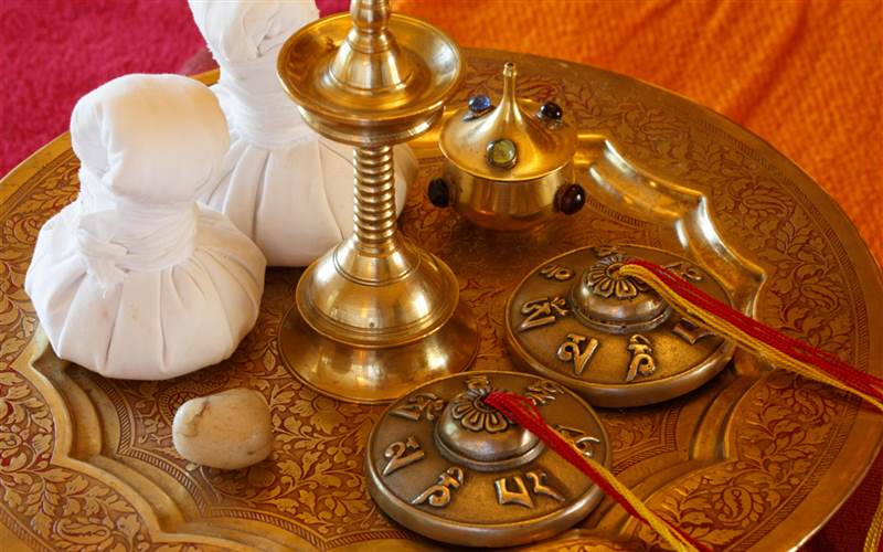 Ayurvedic treatment tray with herbal vessels